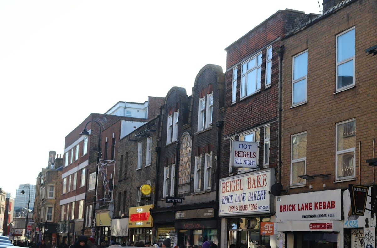 A row of independent shops and cafe signs on Brick Lane in London